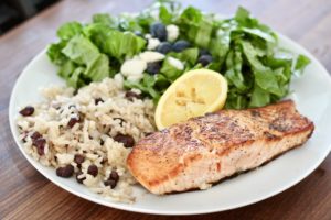 pan fried salmon with rice and salad on white plate how to cook salmon