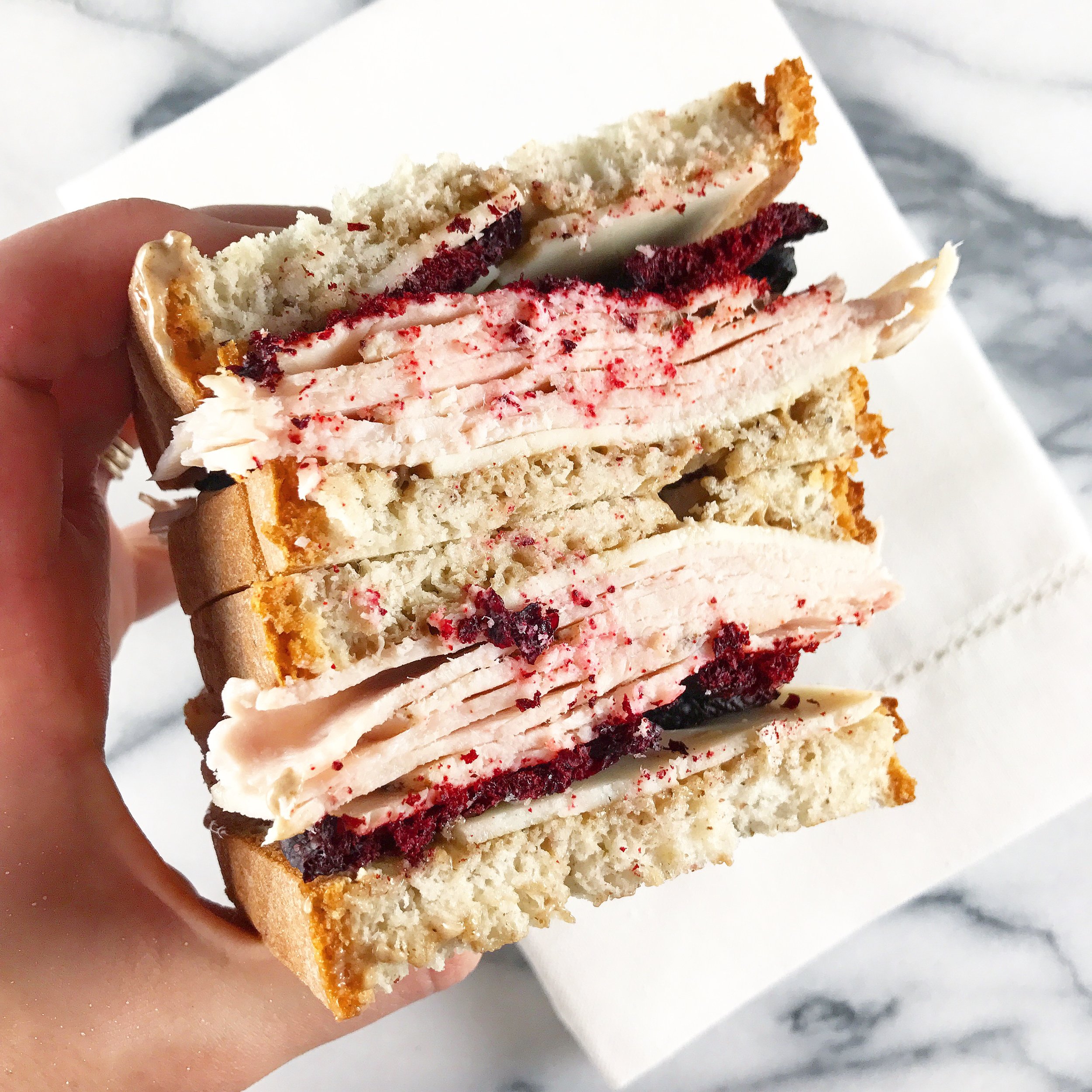 beet chips inside of a turkey sandwich