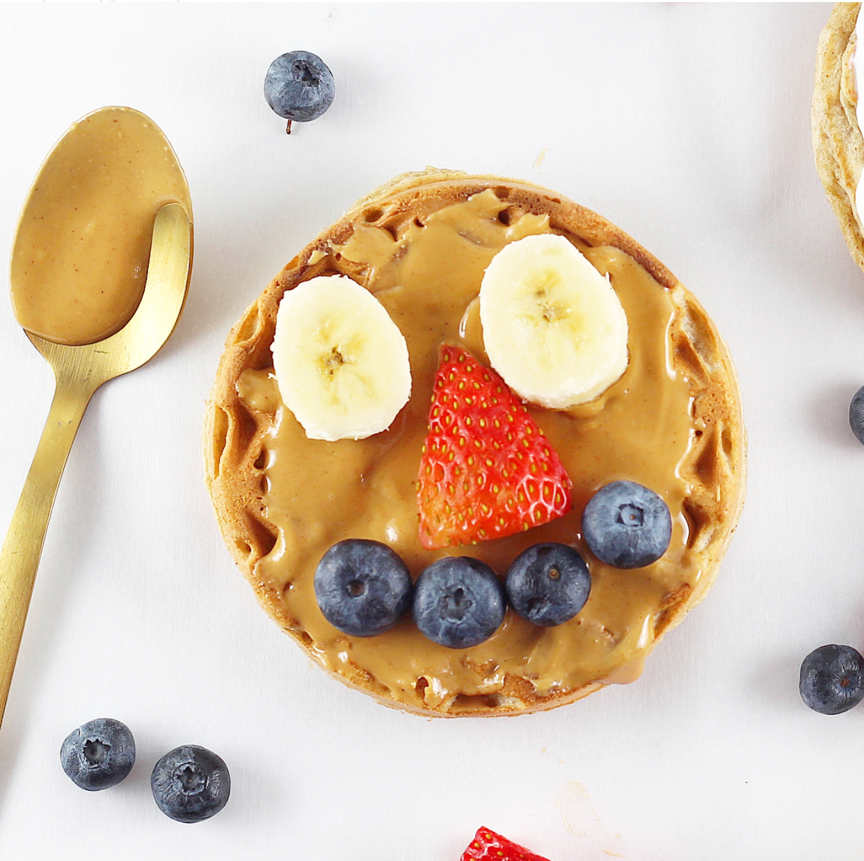 Homemade Toaster Waffles with a smiley face in fruit for Growing Kids