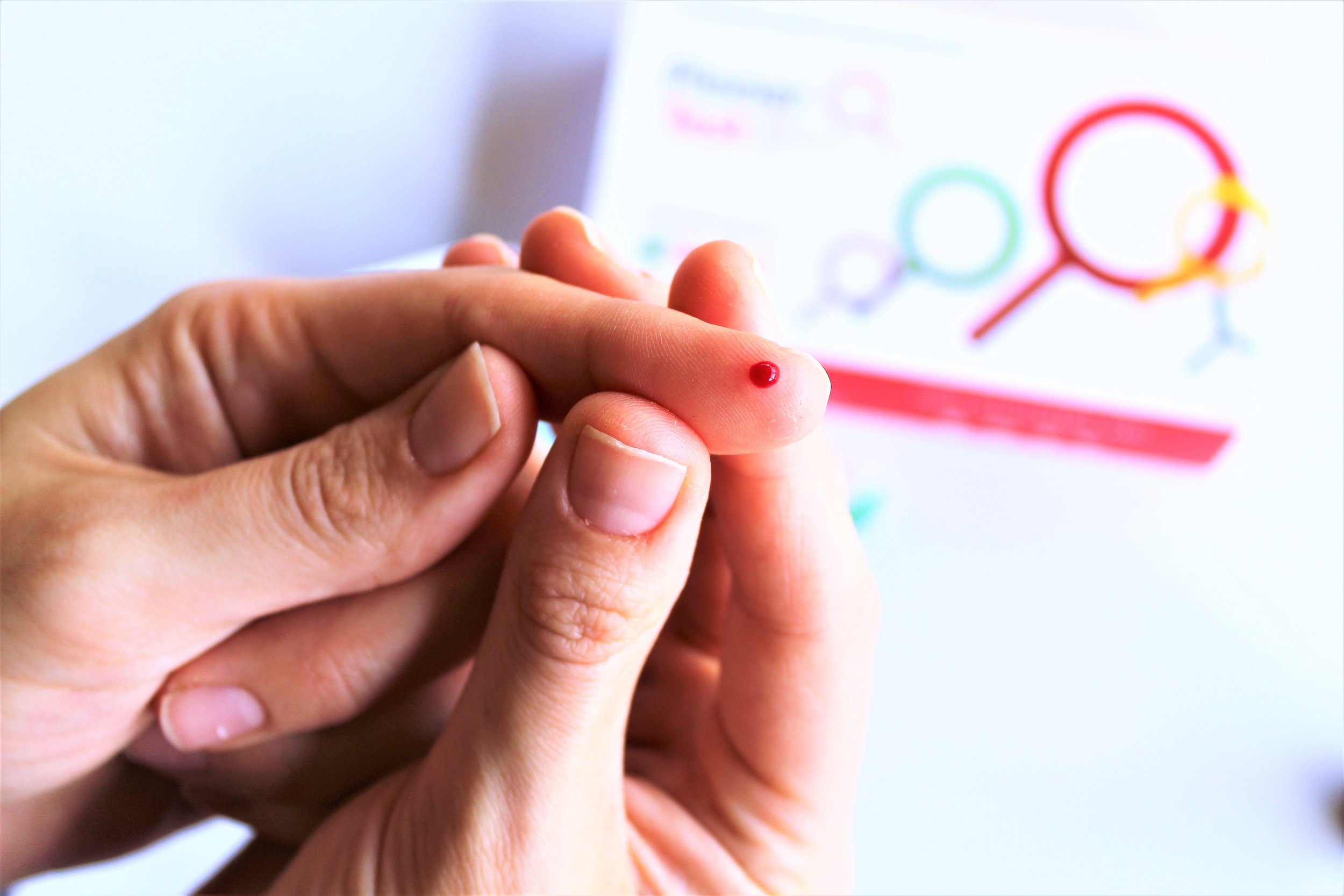 small finger prick with blood for pinner test box kit