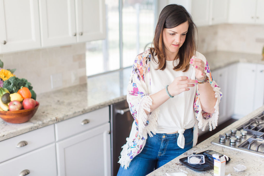 Mary Ellen Phipps measuring insulin dose in kitchen