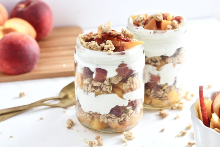 Peaches & Cream Parfaits with Maple Bacon Crumbles in mason jars with peaches on cutting board