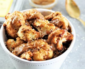 roasted cauliflower with thai peanut sauce in bowl