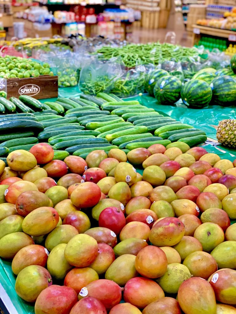 produce section sprouts mango and cucumber watermelon