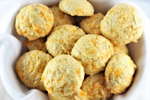 grain free cheesy rolls in a basket with a white cloth