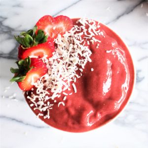 strawberry beet superfood smoothie aerial view with coconut shavings