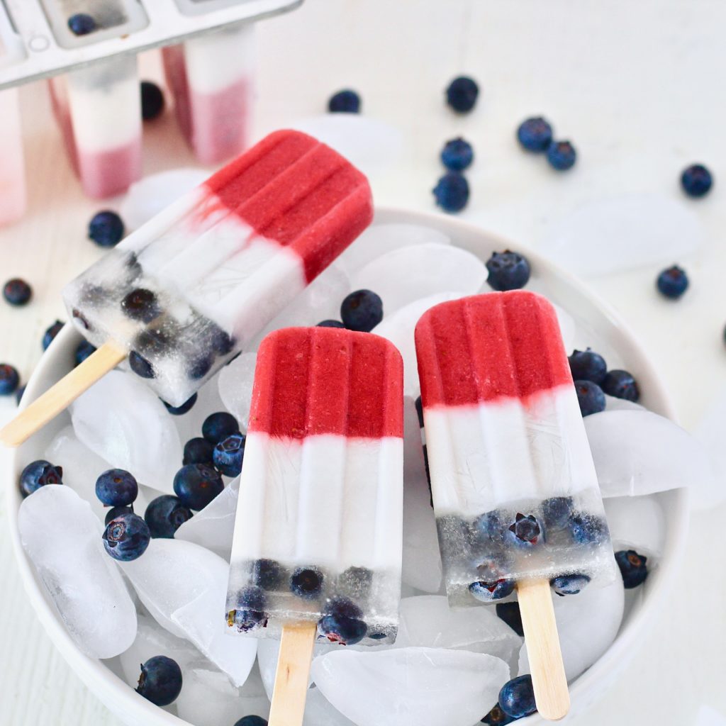 red white and blue fruit popsicles in bowl of ice