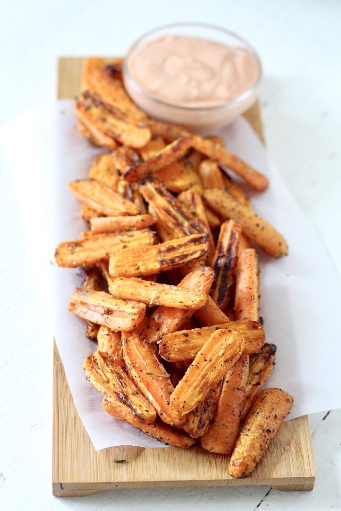 carrots cooked in air fryer on cutting board with dipping sauce