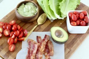 blt lettuce wrap ingredients on wood cutting board