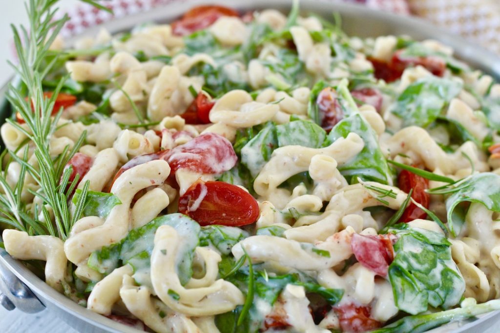 pasta dish with tomatoes and spinach