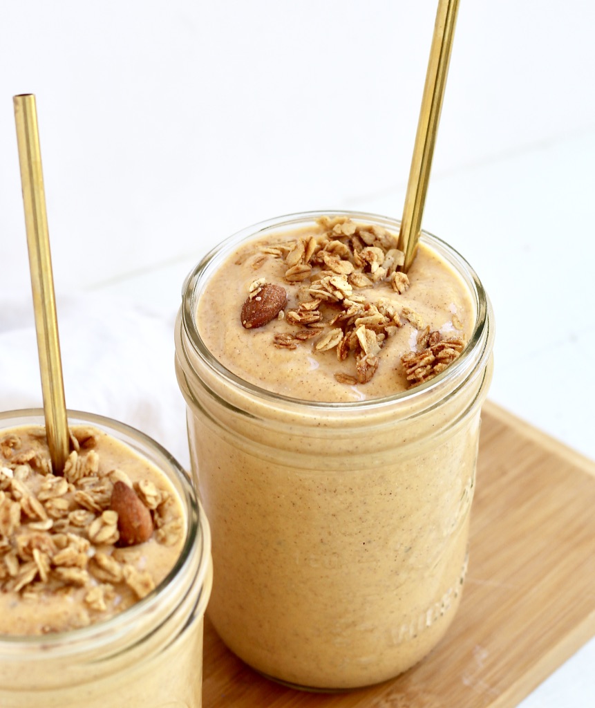 two sweet potato smoothies in mason jars with gold metal straws