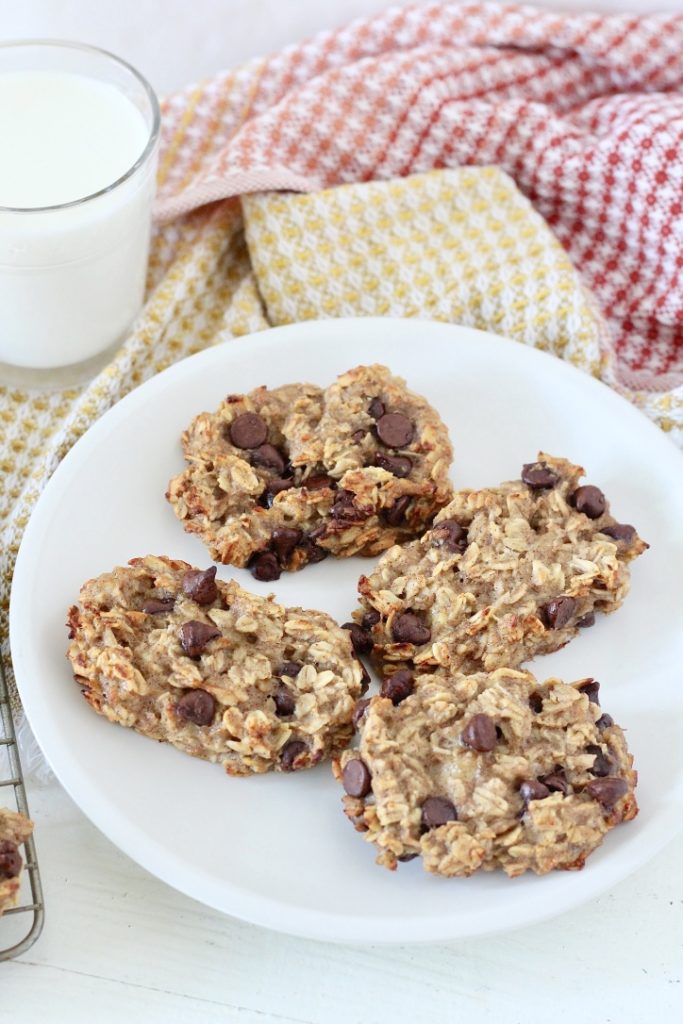 oatmeal chocolate chip bars on white plate with glass of milk