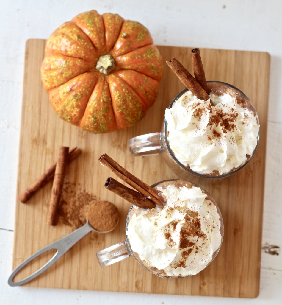 pumpkin next to hot chocolate on cutting board