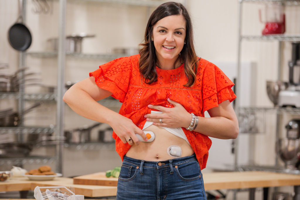 women inserting the continuous glucose monitor