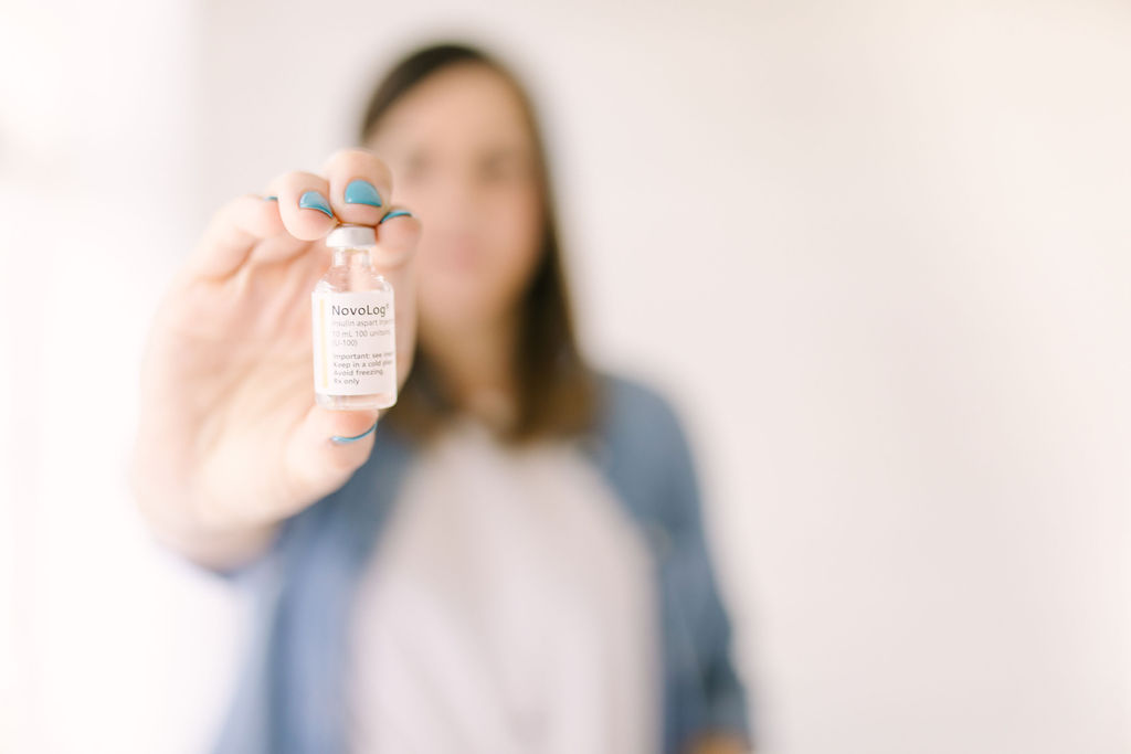 woman holding vial of insulin