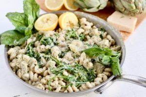 artichoke pesto pasta in stainless steel pan