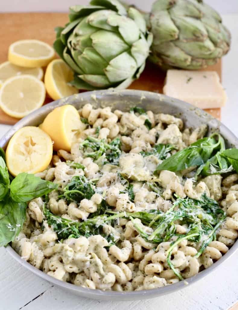 artichoke pesto pasta in stainless steel pan