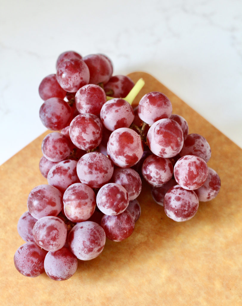 red seedless california grapes on cutting board