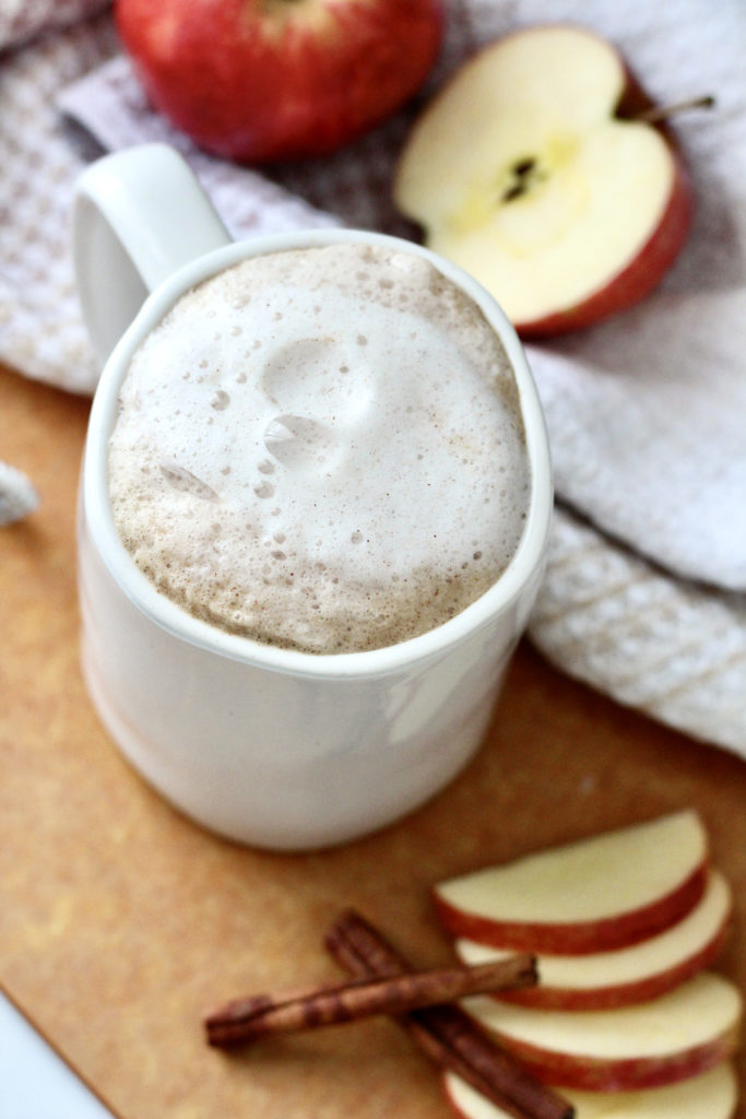 apple crisp macchiato with foam in white mug