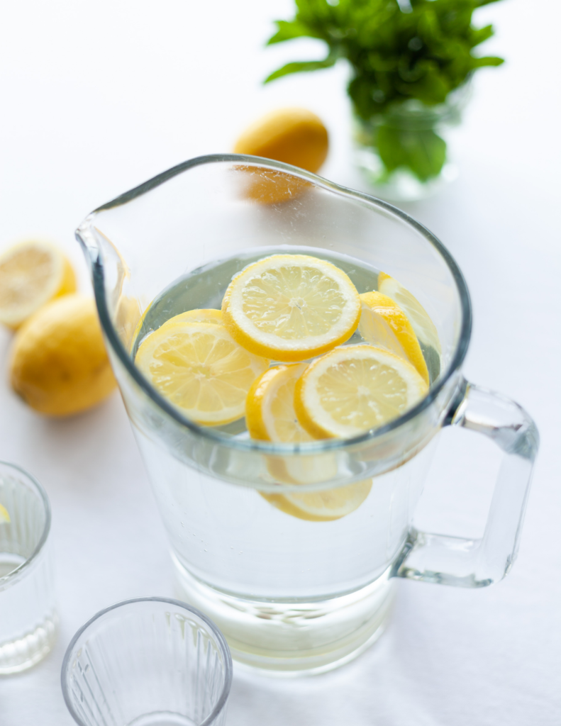 pitcher of water with lemon slices dehydration from intermittent fasting