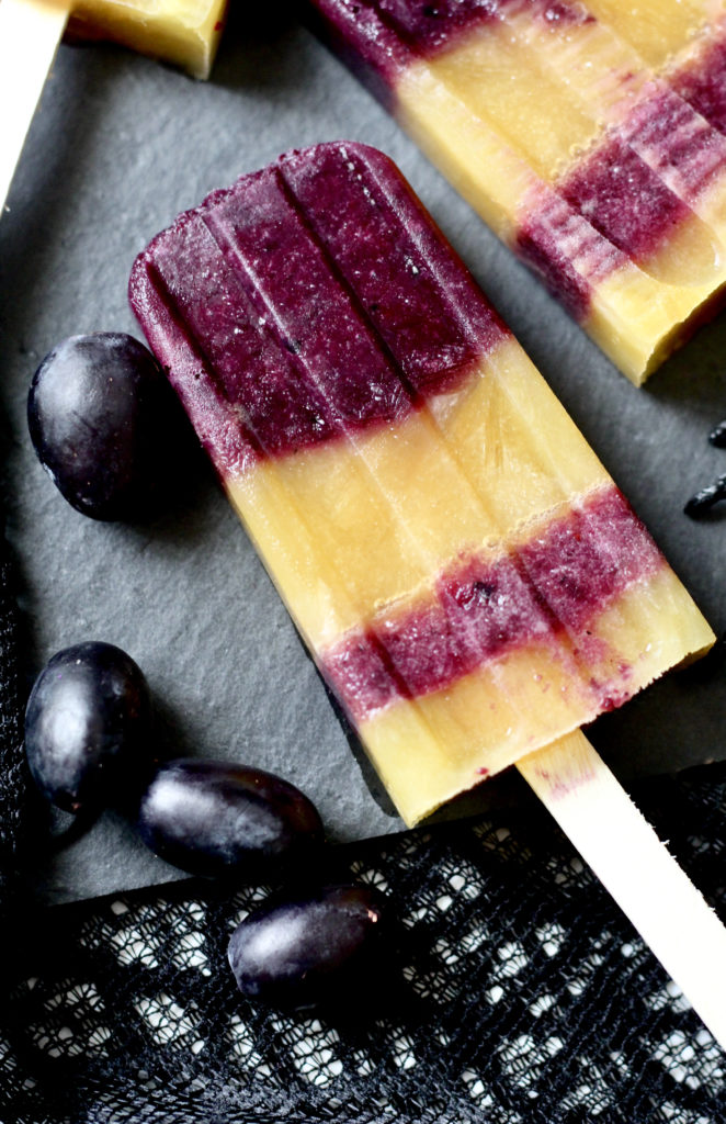 orange juice and black grape popsicles