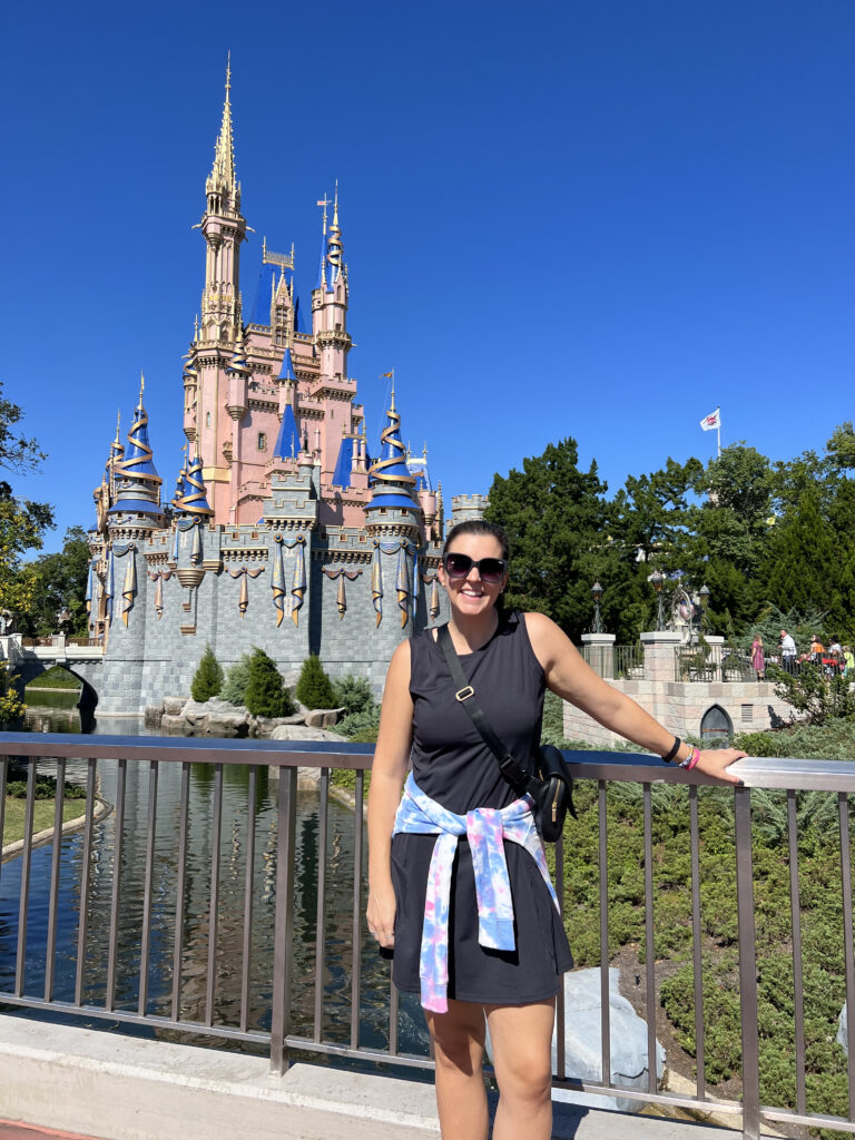 woman with type 1 diabetes at disney world cinderella's castle